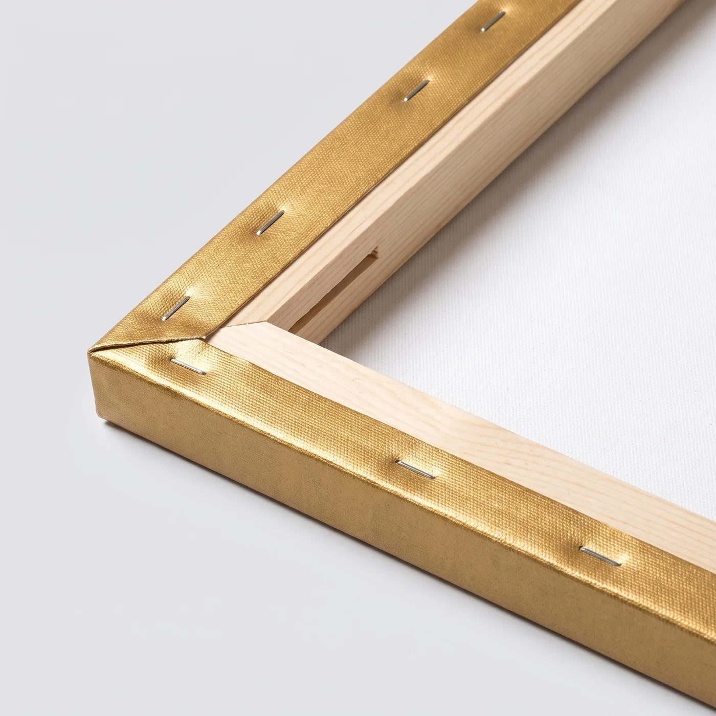 Back of the MIDAS gold canvas — spruce frame, staples, and folded gold edge