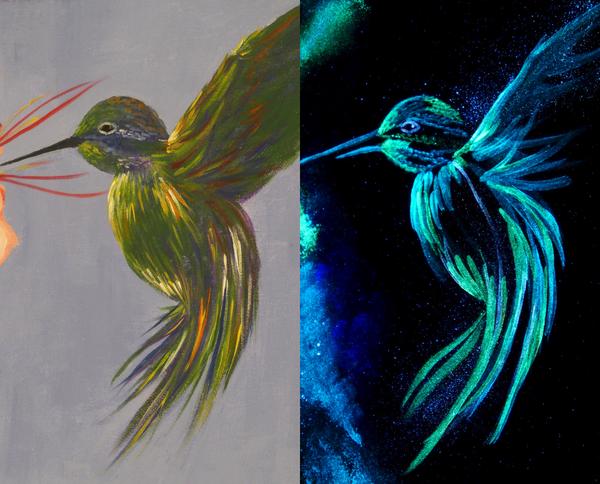 Artist Painting with Glow-in-the-Dark Paints on a Dark Surface