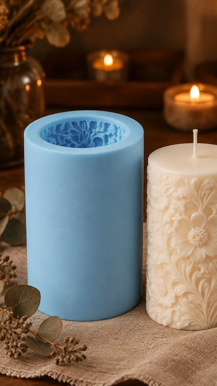 Tall blue silicone candle mold with a cast wax candle featuring a floral relief